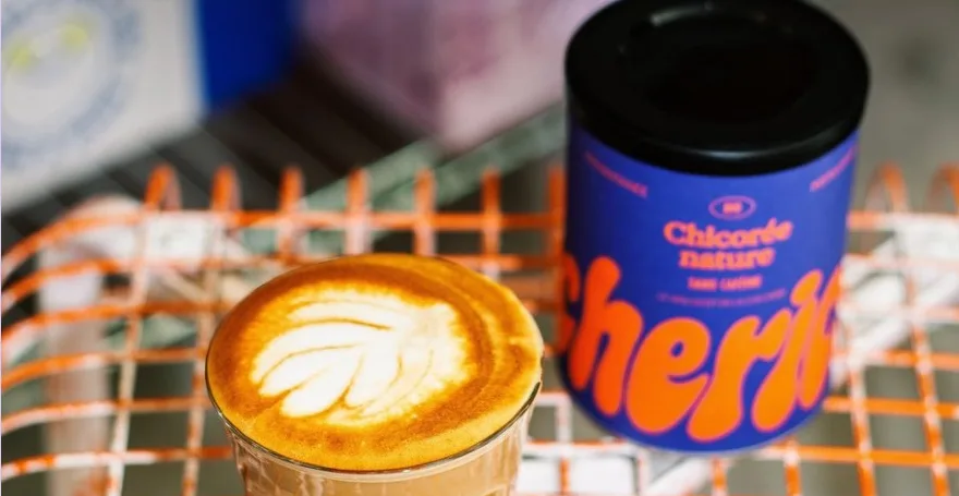 A tin of Cherico chicory next to a milky drink