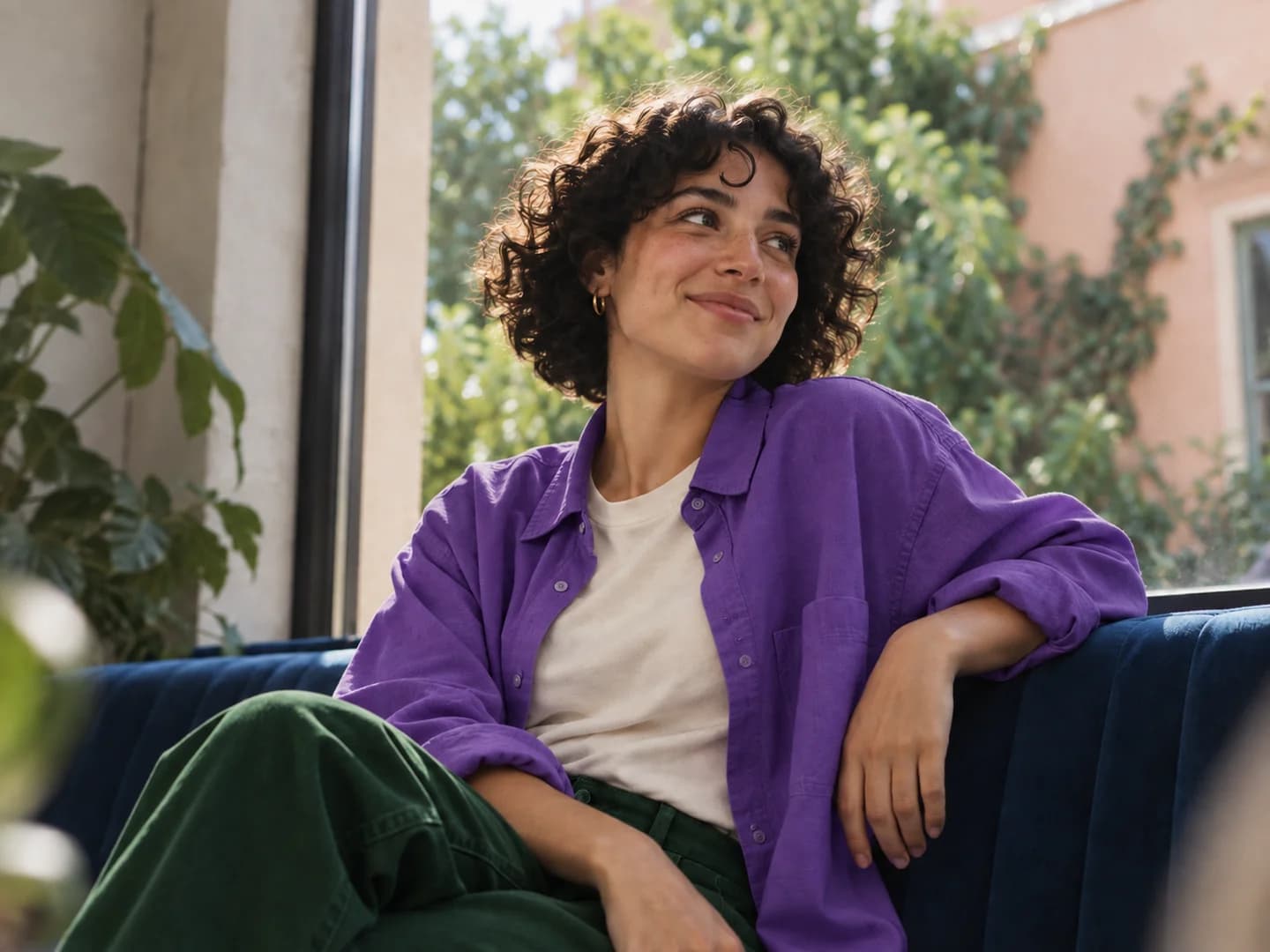 Illustrative portrait of a woman in a purple shirt sitting by a window.